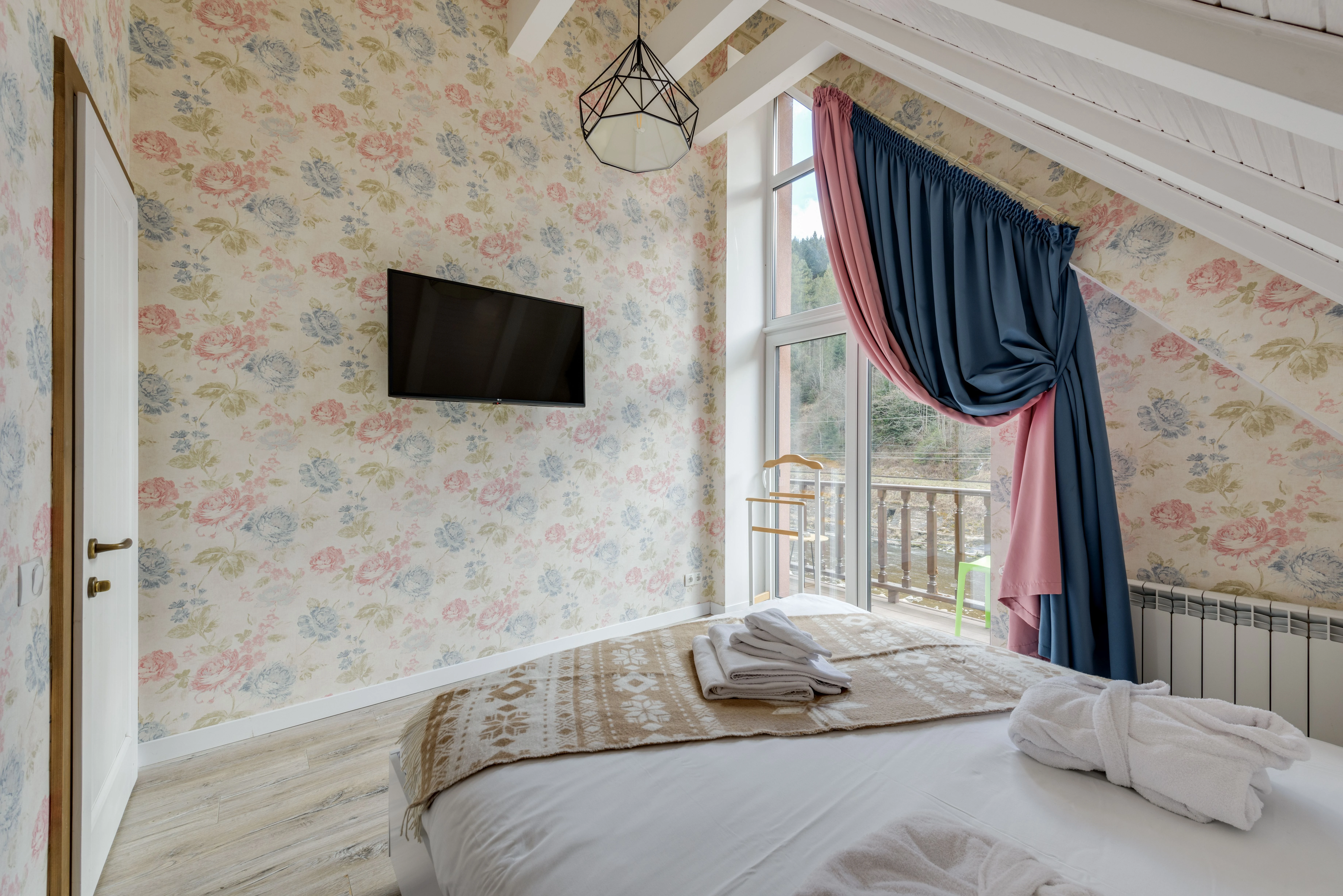 Soft floral wallpaper in a serene, light-filled bedroom