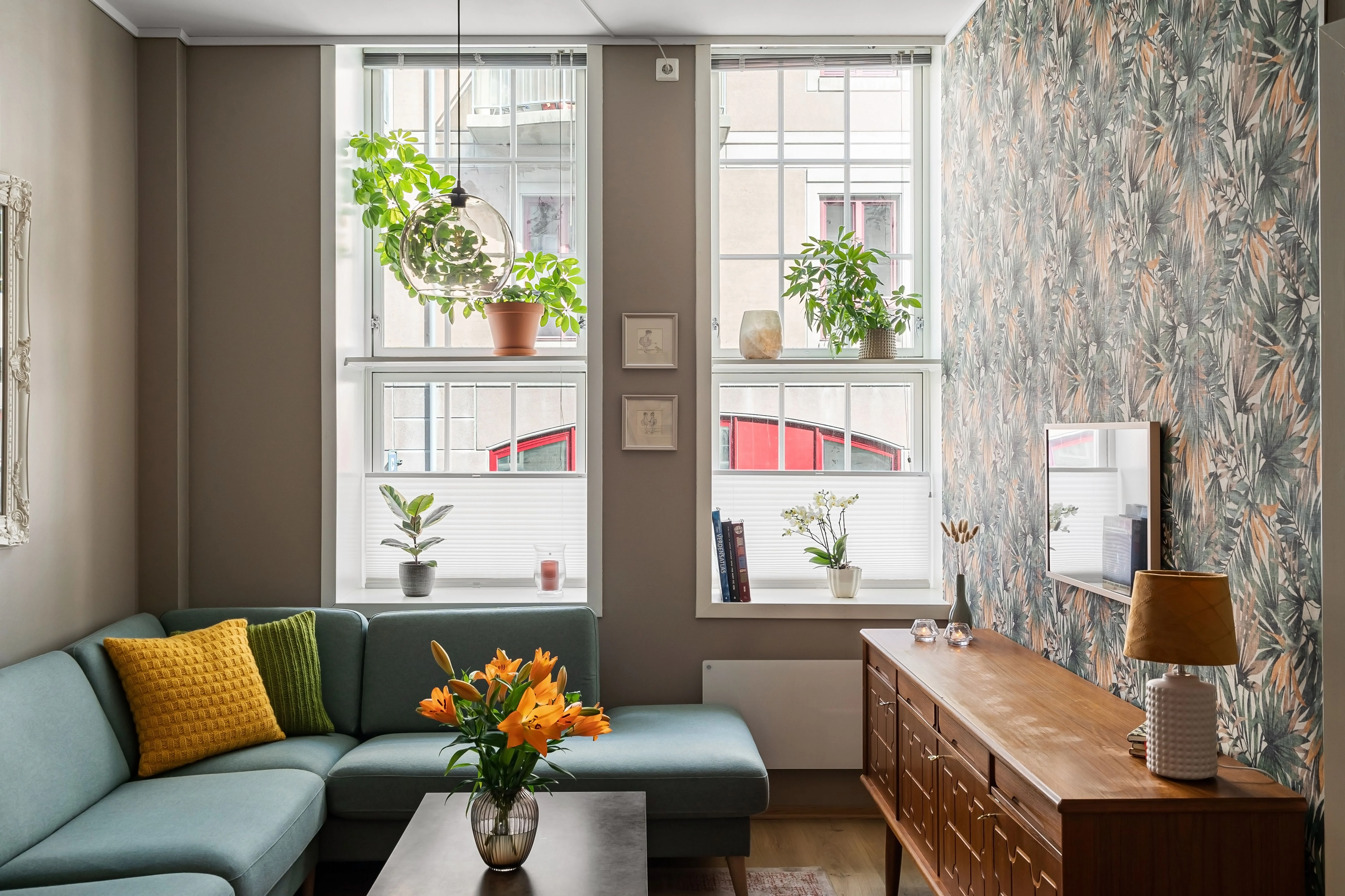 A polished living room finished with leafy botanical wallpaper